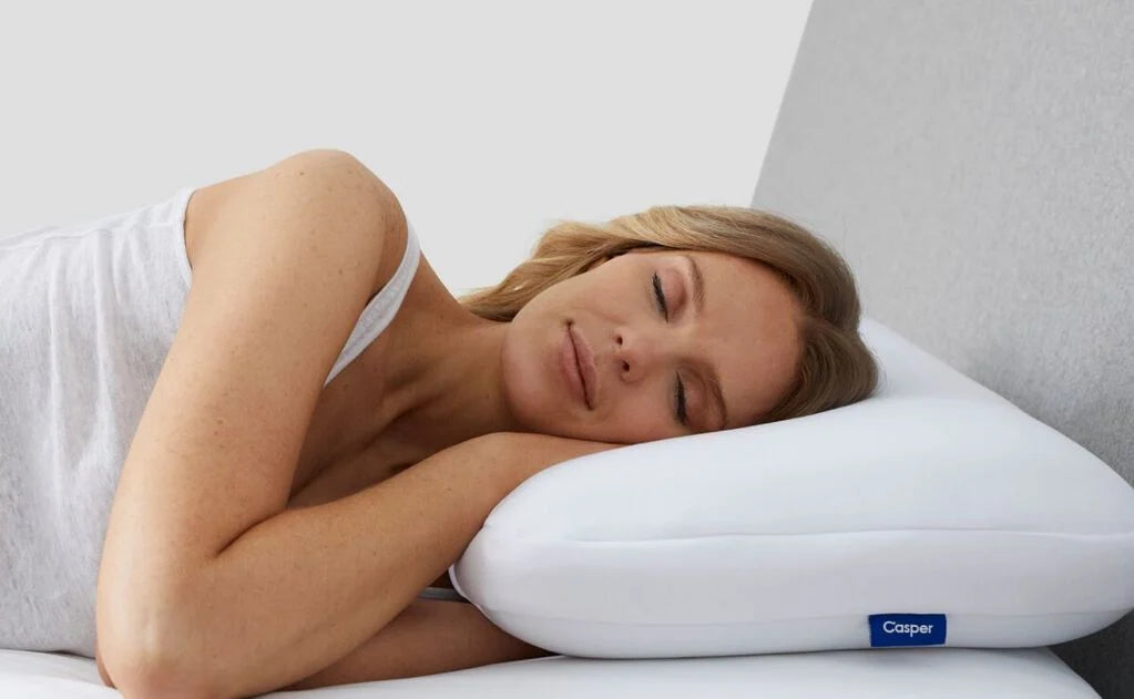 close-up of a woman's head lying sideways on a pillow