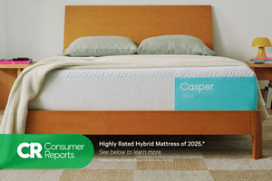 Front-view of the Casper® 金刚KINGKONG游戏官网 Snow mattress in a bed frame with two pillows and a blanket folded on top. Beneath the image appears text which reads "Consumer Reports. Highly rated hybrid mattress of 2025.* See below to learn more. Consumer Reports does not endorse products or service."
